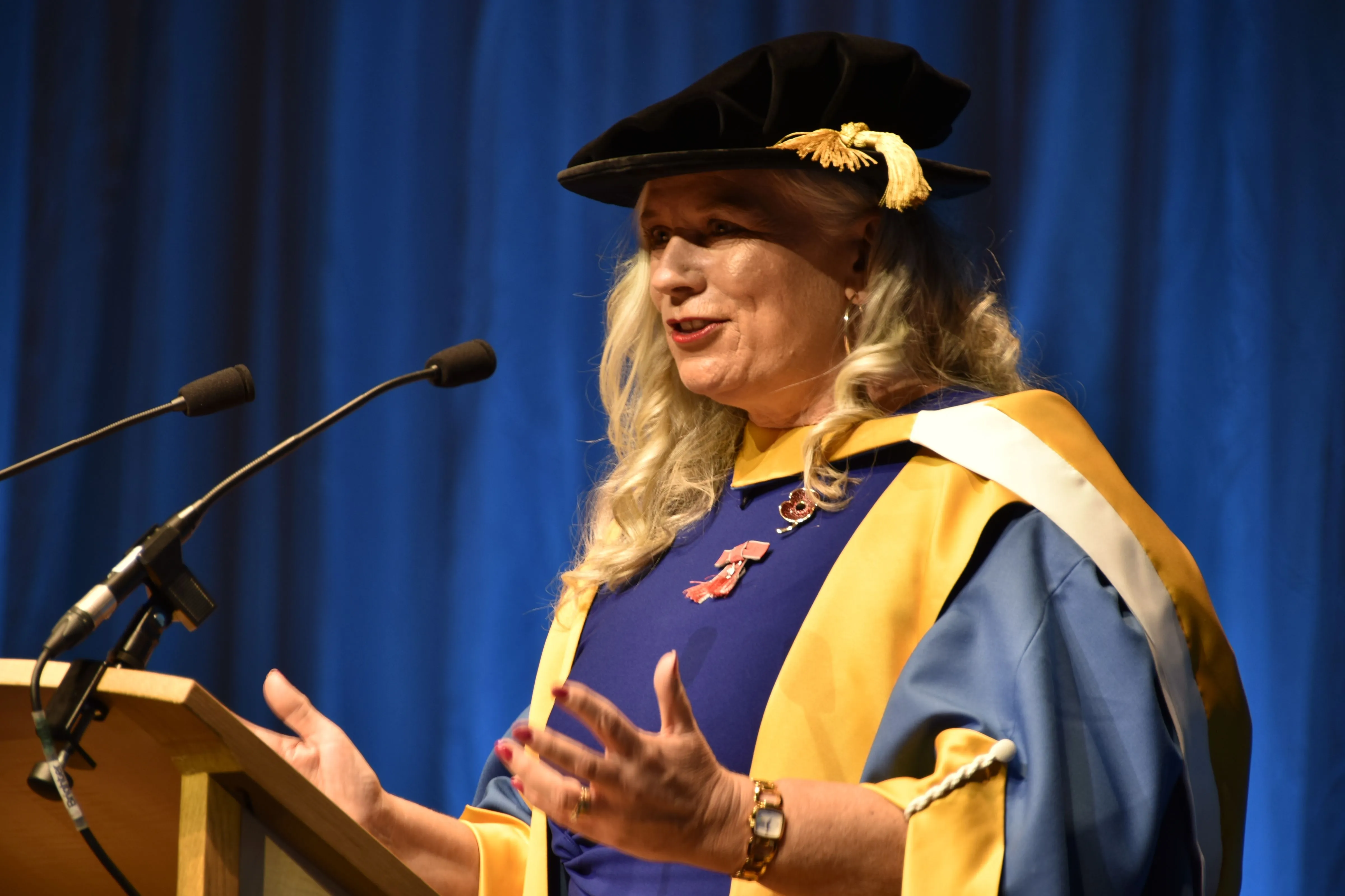 Dr Alison Edgar speaking in doctoral robes at her honorary graduation ceremony.
